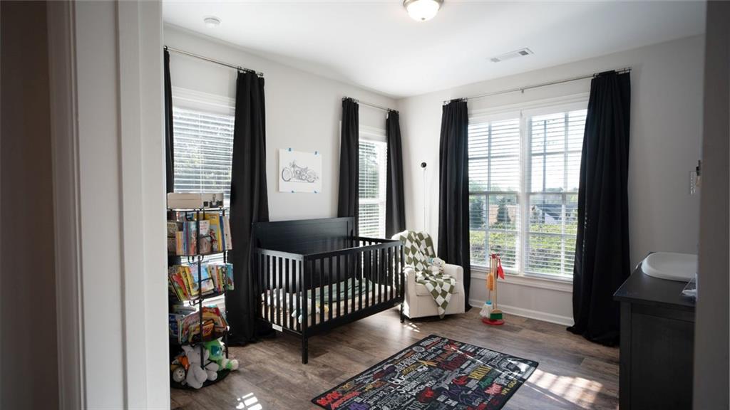 6165 Namon Wallace Road Cumming, GA 30028 - Photo 20 of 30 a bedroom with a bed and a book shelf