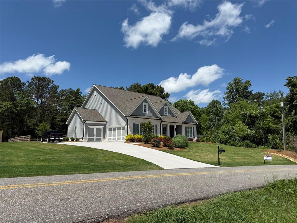 6165 Namon Wallace Road Cumming, GA 30028 - Photo 2 of 30 a view of a house with a big yard