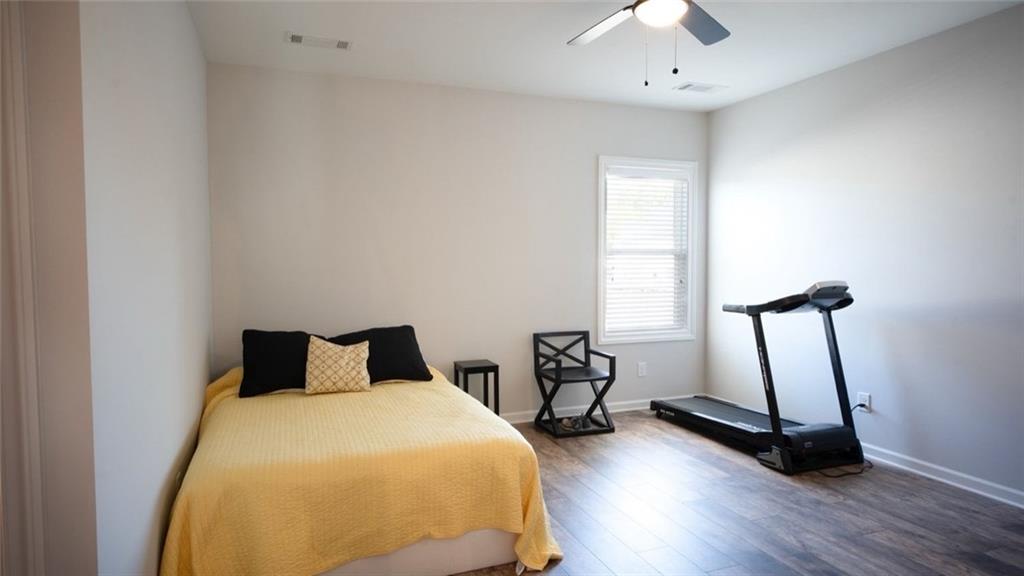 6165 Namon Wallace Road Cumming, GA 30028 - Photo 23 of 30 a bedroom with a bed and a window