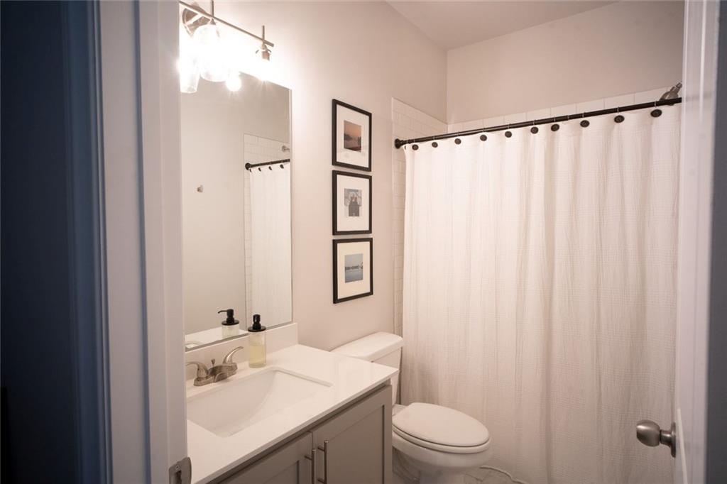 6165 Namon Wallace Road Cumming, GA 30028 - Photo 25 of 30 a bathroom with a sink a toilet and shower