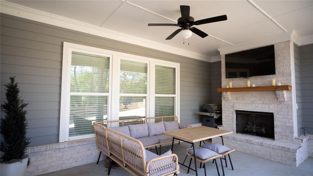 6165 Namon Wallace Road Cumming, GA 30028 - Photo 28 of 30 a dining room with furniture window and a fireplace