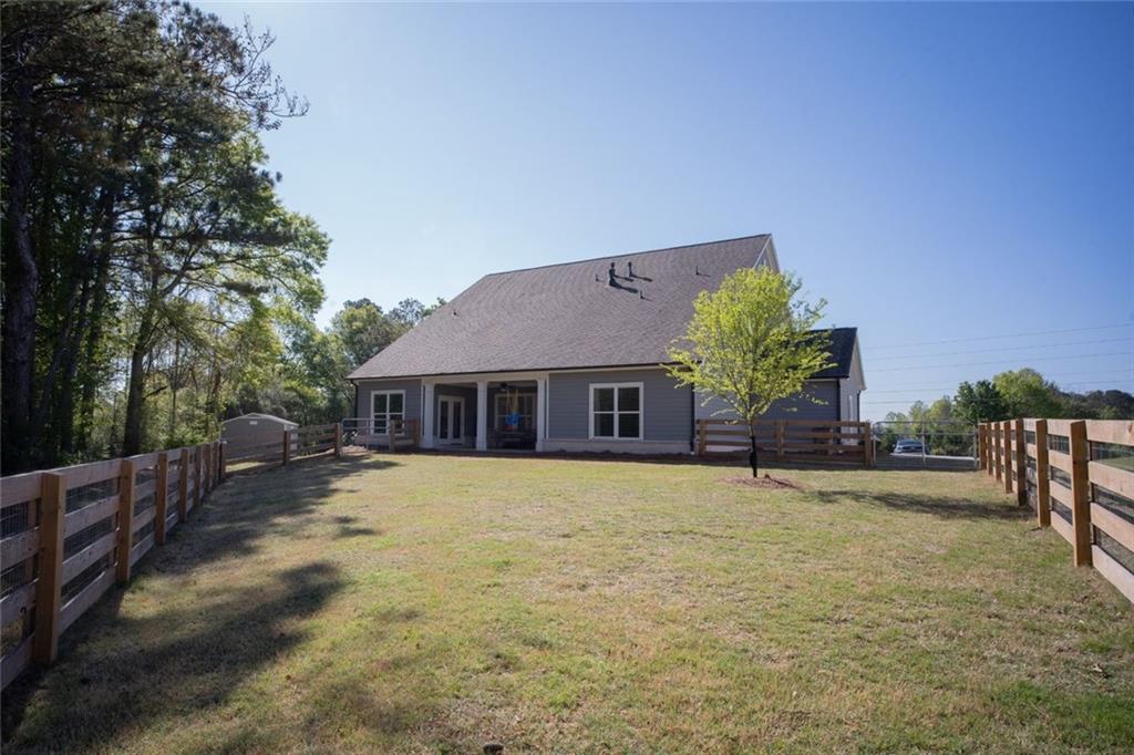 6165 Namon Wallace Road Cumming, GA 30028 - Photo 29 of 30 a front view of house with yard and trees in the background
