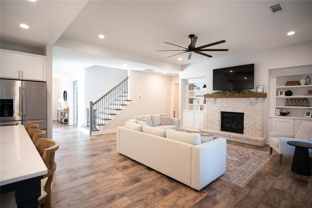 6165 Namon Wallace Road Cumming, GA 30028 - Photo 6 of 30 a living room with furniture a flat screen tv and a fireplace