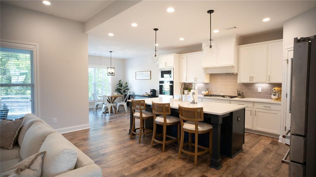 6165 Namon Wallace Road Cumming, GA 30028 - Photo 8 of 30 a large kitchen with a table and chairs