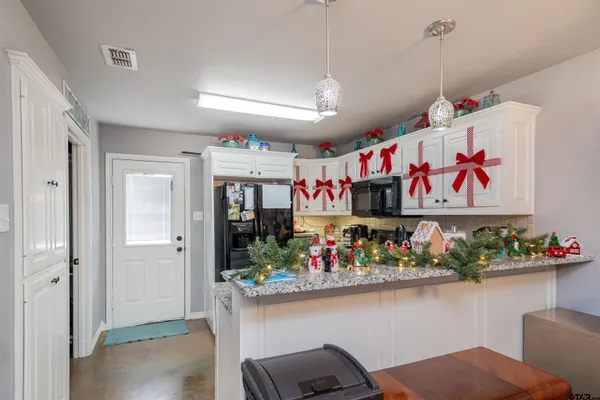 a kitchen with a refrigerator and a sink