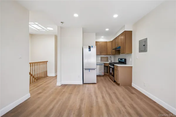 a kitchen with stainless steel appliances granite countertop a refrigerator and a stove top oven