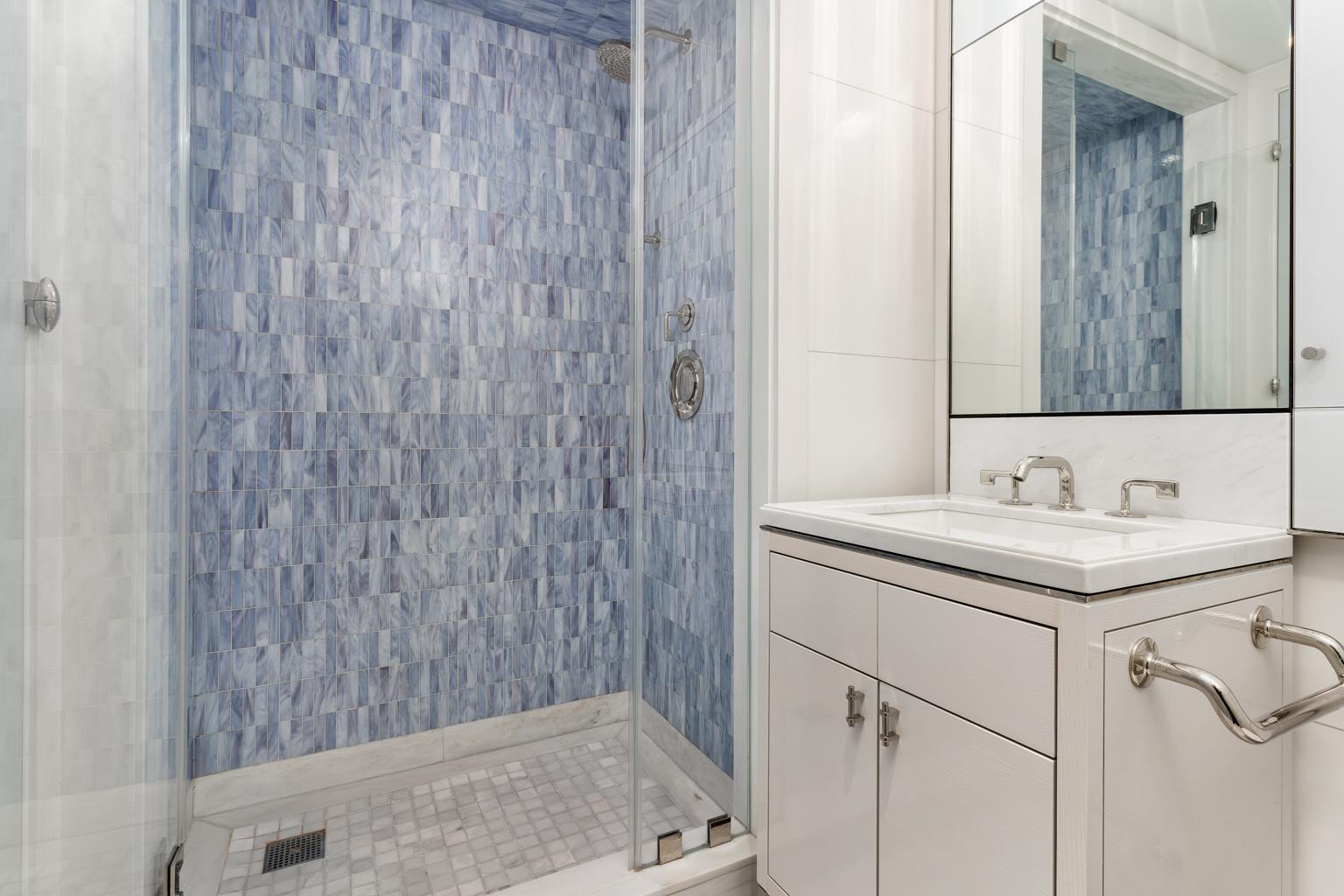 21 East 61st Street, Unit 9C Manhattan, NY 10065 - Photo 11 of 19 a bathroom with a granite countertop sink and a mirror