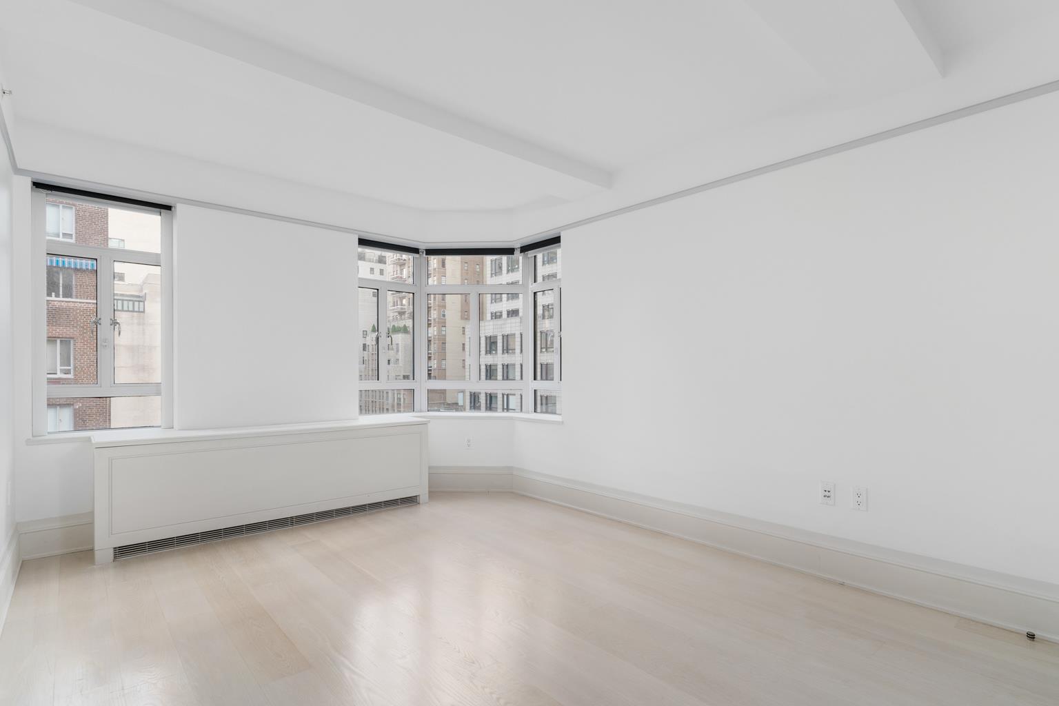 21 East 61st Street, Unit 9C Manhattan, NY 10065 - Photo 16 of 19 an empty room with windows