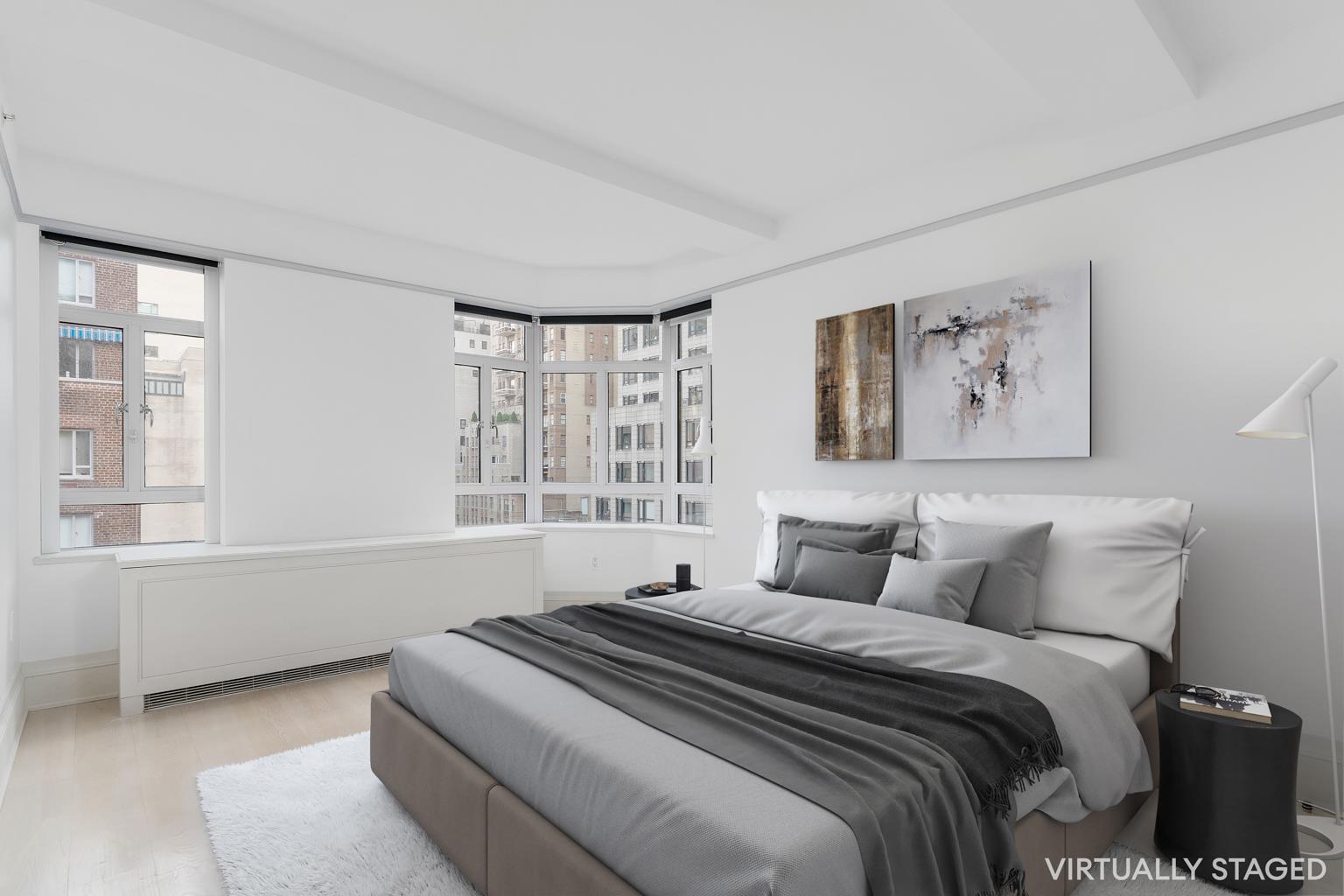 21 East 61st Street, Unit 9C Manhattan, NY 10065 - Photo 3 of 19 a bedroom with a large bed and a window