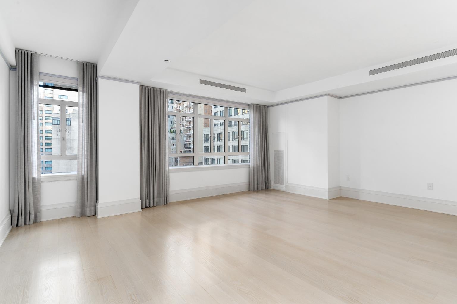 21 East 61st Street, Unit 9C Manhattan, NY 10065 - Photo 4 of 19 a view of an empty room with a window