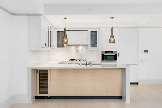 a kitchen with stainless steel appliances a sink and a refrigerator