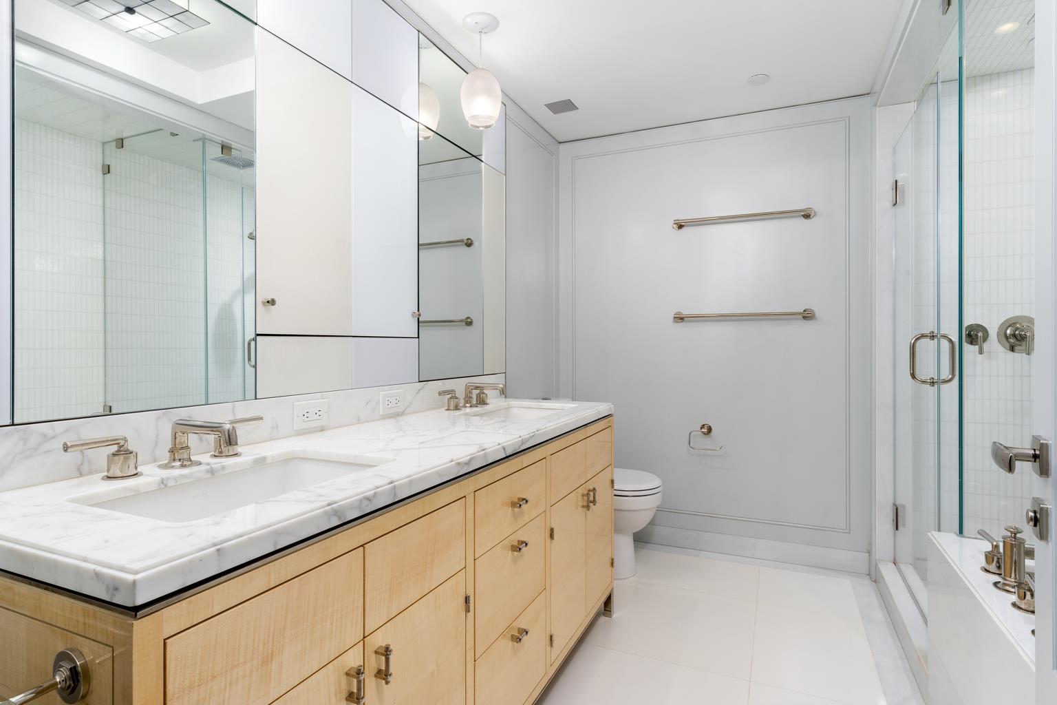 21 East 61st Street, Unit 9C Manhattan, NY 10065 - Photo 9 of 19 a bathroom with a granite countertop sink a toilet and shower