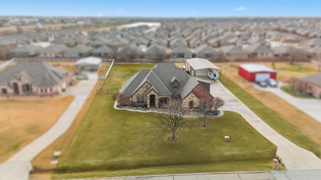 an aerial view of a house with a yard