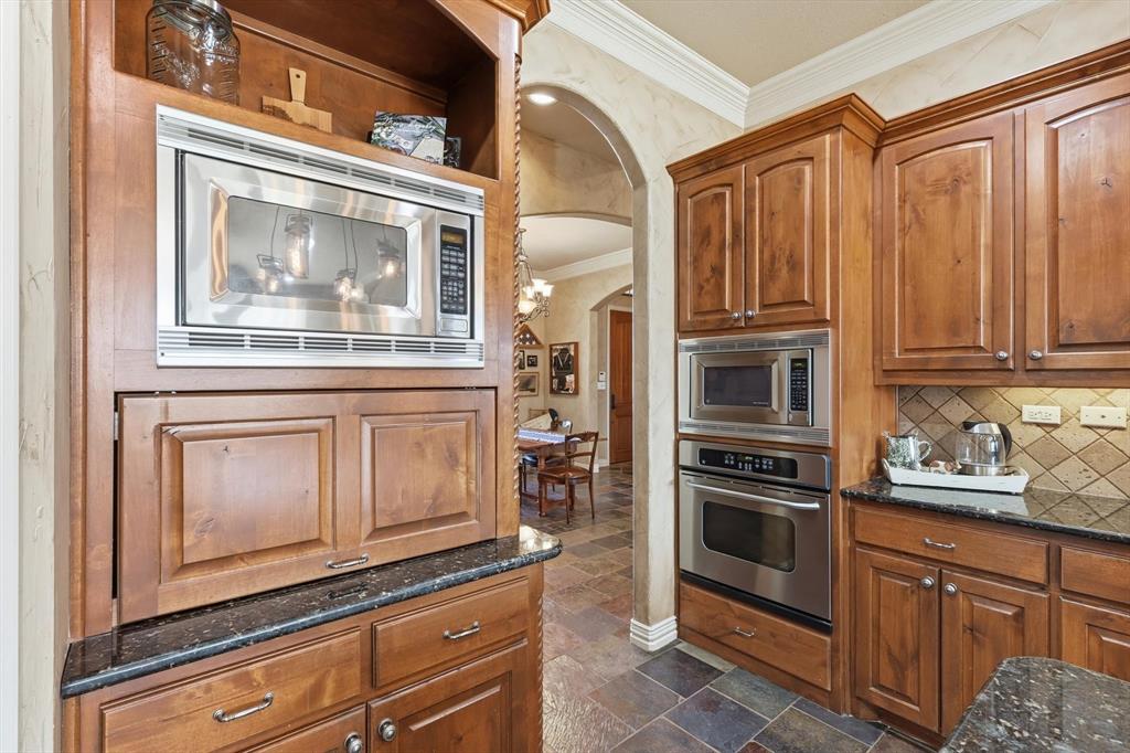 209 Lonesome Prairie Trail Haslet, TX 76052 - Photo 11 of 40 a kitchen with stainless steel appliances granite countertop a refrigerator oven and granite counter tops