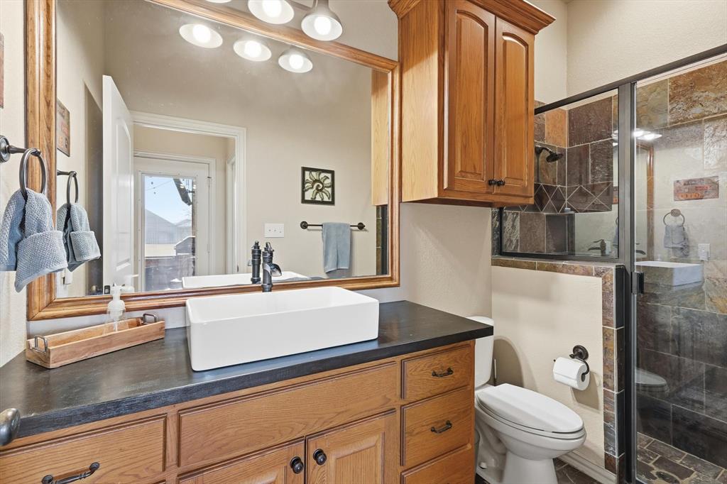209 Lonesome Prairie Trail Haslet, TX 76052 - Photo 20 of 40 a bathroom with a sink a toilet and a mirror