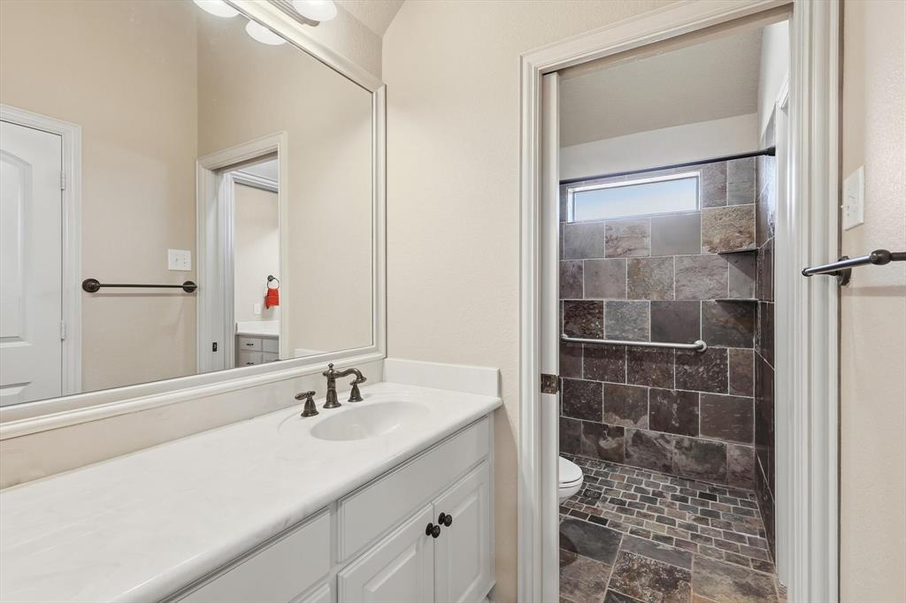 209 Lonesome Prairie Trail Haslet, TX 76052 - Photo 22 of 40 a bathroom with a shower sink and mirror