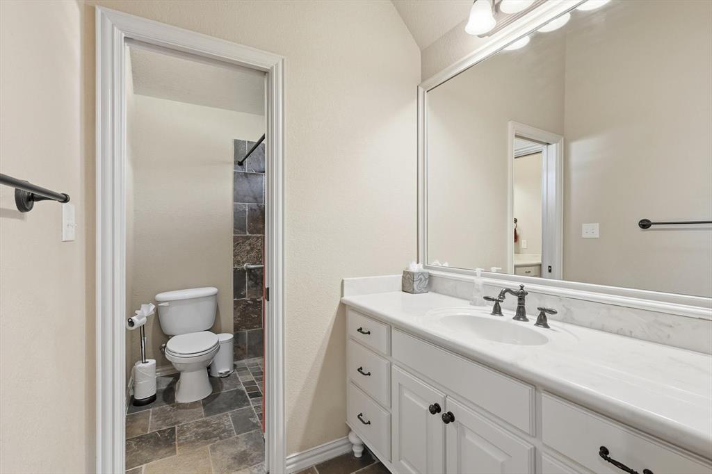 209 Lonesome Prairie Trail Haslet, TX 76052 - Photo 23 of 40 a bathroom with a double vanity sink toilet and shower