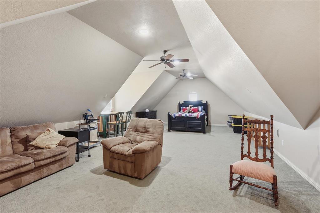 209 Lonesome Prairie Trail Haslet, TX 76052 - Photo 25 of 40 a living room with furniture and a chandelier