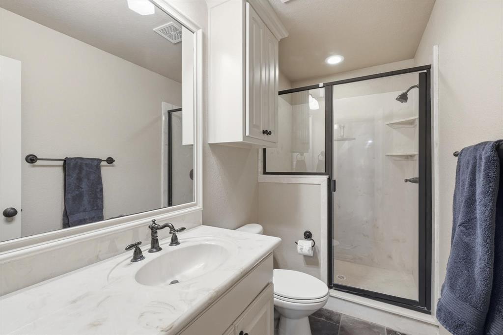 209 Lonesome Prairie Trail Haslet, TX 76052 - Photo 26 of 40 a bathroom with a granite countertop sink toilet and shower