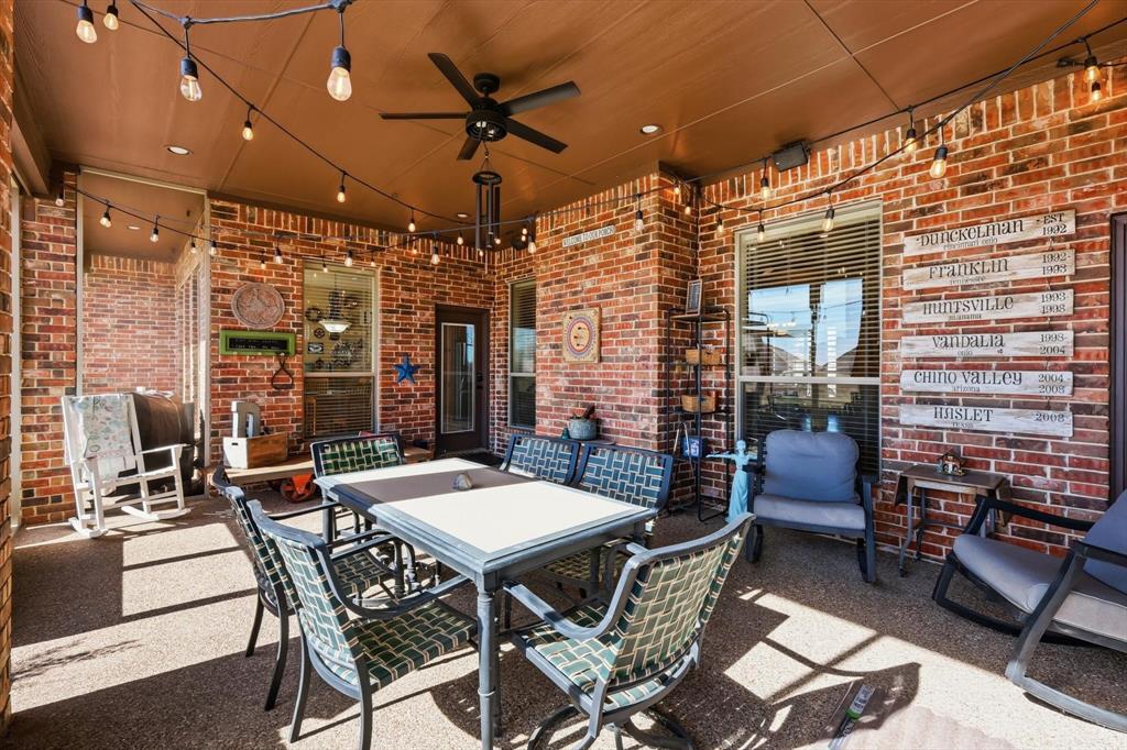 209 Lonesome Prairie Trail Haslet, TX 76052 - Photo 30 of 40 a view of a patio with a dining table and chairs