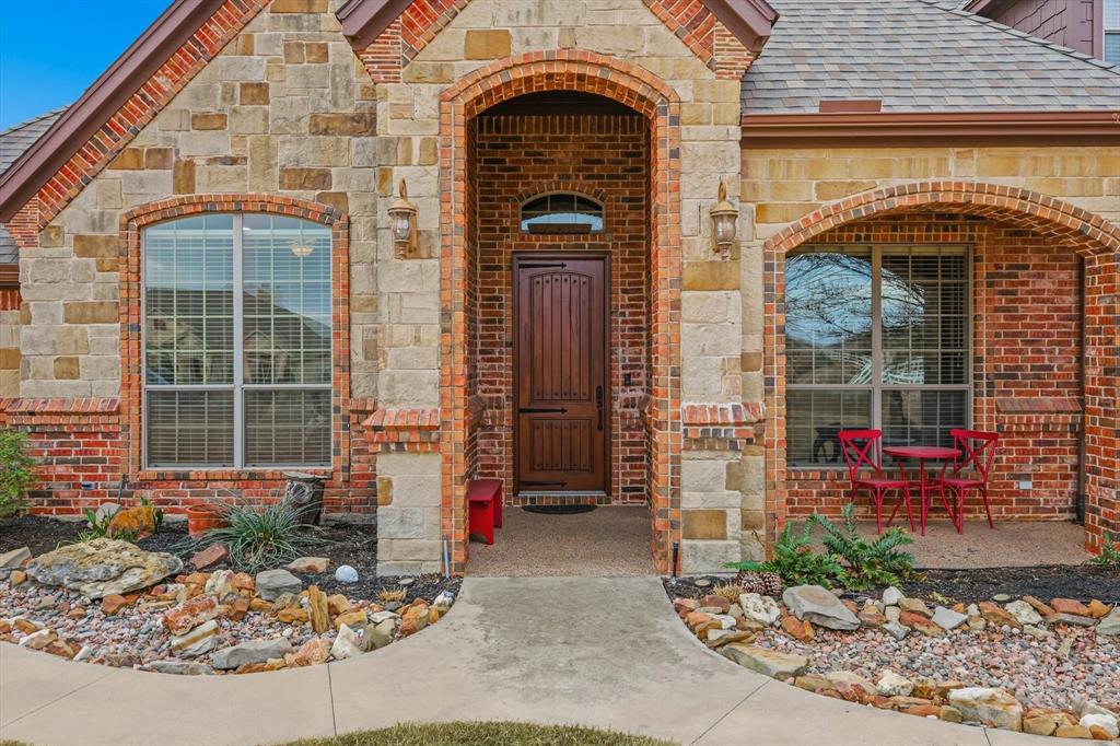 209 Lonesome Prairie Trail Haslet, TX 76052 - Photo 3 of 40 a front view of a house with garden