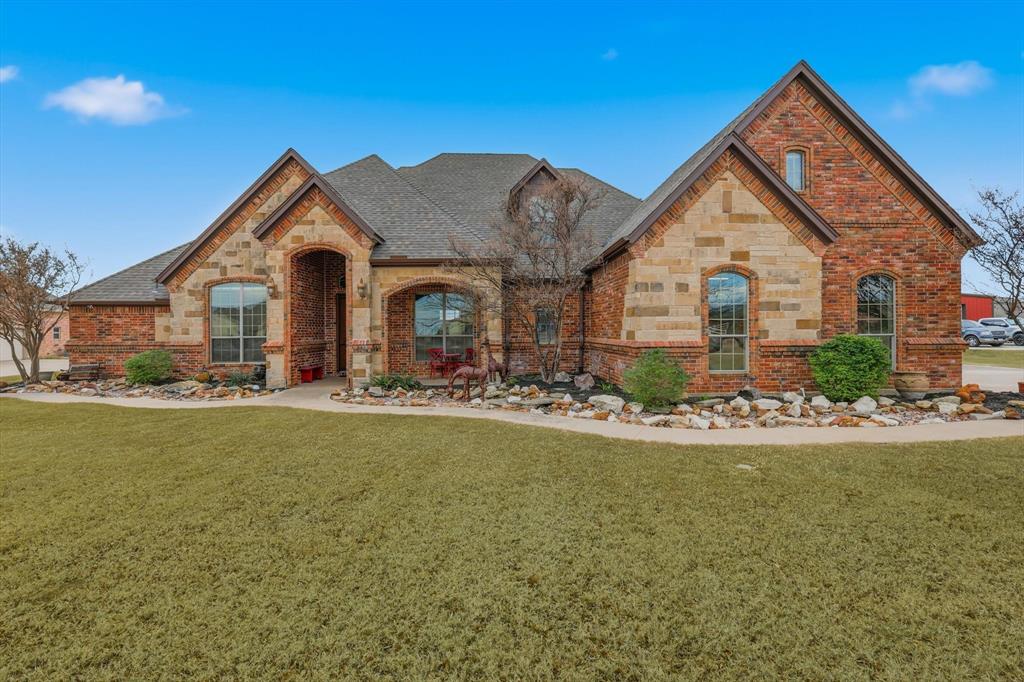 209 Lonesome Prairie Trail Haslet, TX 76052 - Photo 38 of 40 a front view of house with yard and green space