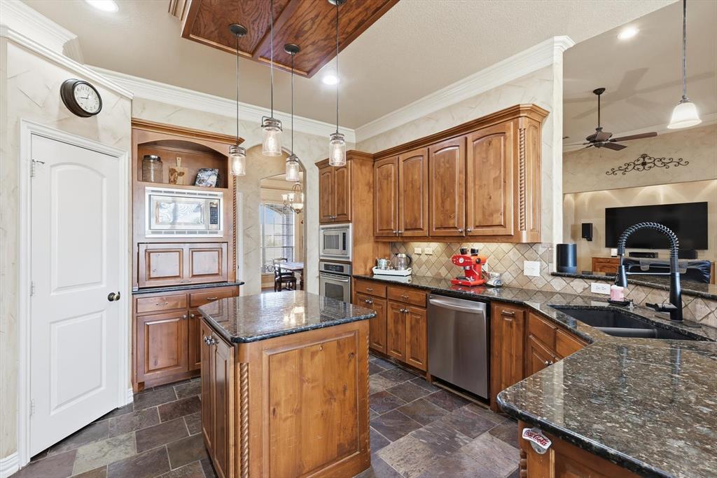 209 Lonesome Prairie Trail Haslet, TX 76052 - Photo 10 of 40 a kitchen with stainless steel appliances granite countertop a sink stove and refrigerator