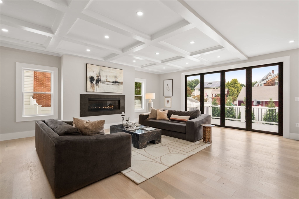 48 Cypress Road Milton, MA 02186 - Photo 11 of 39 a living room with furniture large window and a fireplace