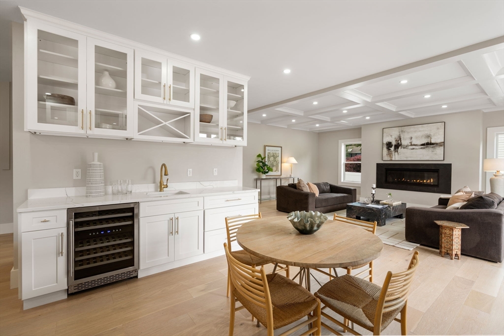 48 Cypress Road Milton, MA 02186 - Photo 12 of 39 a kitchen with a stove a sink a dining table and chairs