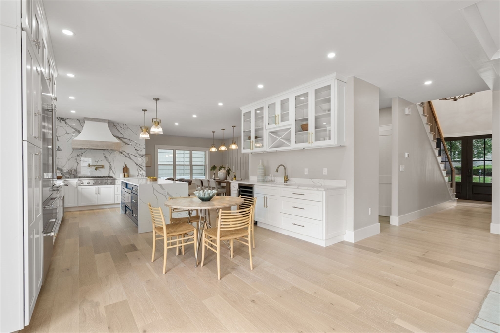 48 Cypress Road Milton, MA 02186 - Photo 13 of 39 a dining hall with stainless steel appliances kitchen island granite countertop a stove a table and chairs