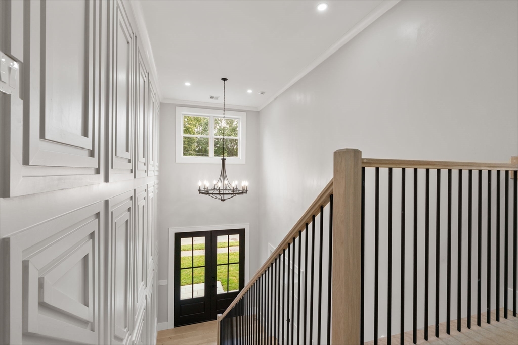 48 Cypress Road Milton, MA 02186 - Photo 19 of 39 a view of hallway with stairs and wooden floor
