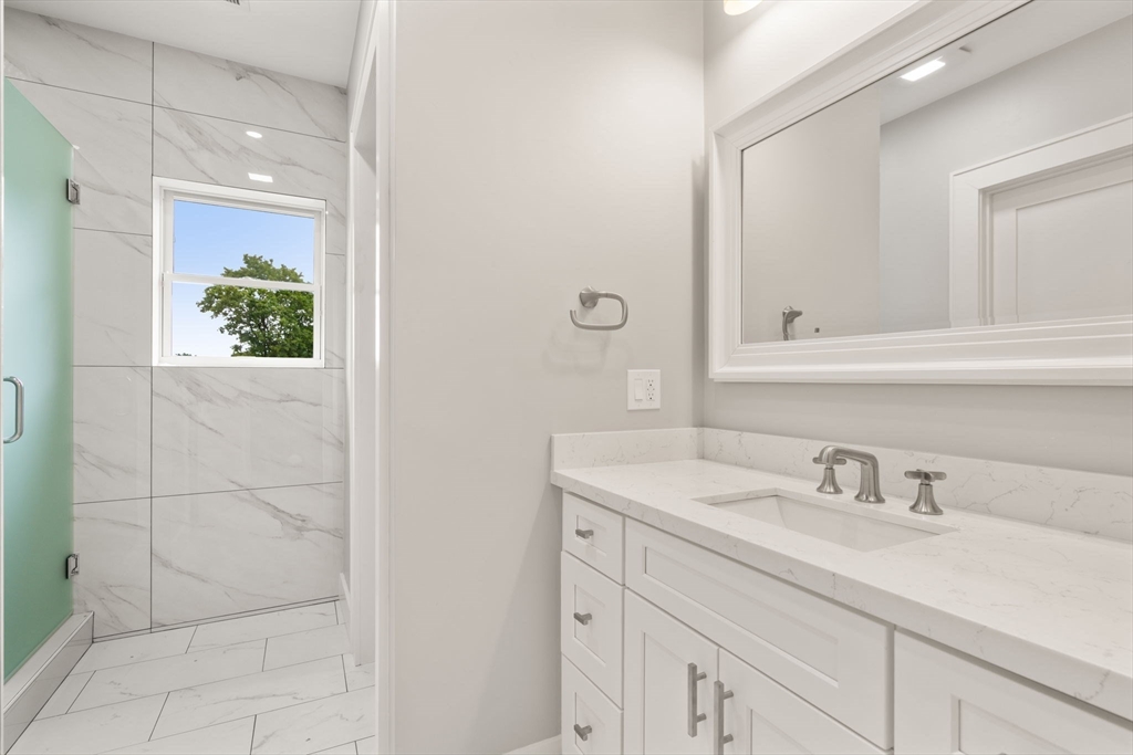 48 Cypress Road Milton, MA 02186 - Photo 25 of 39 a bathroom with a sink and a mirror