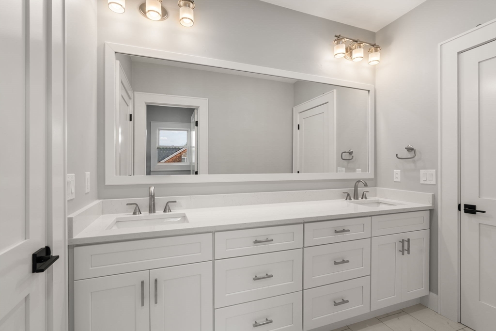 48 Cypress Road Milton, MA 02186 - Photo 27 of 39 a bathroom with double sink and a mirror