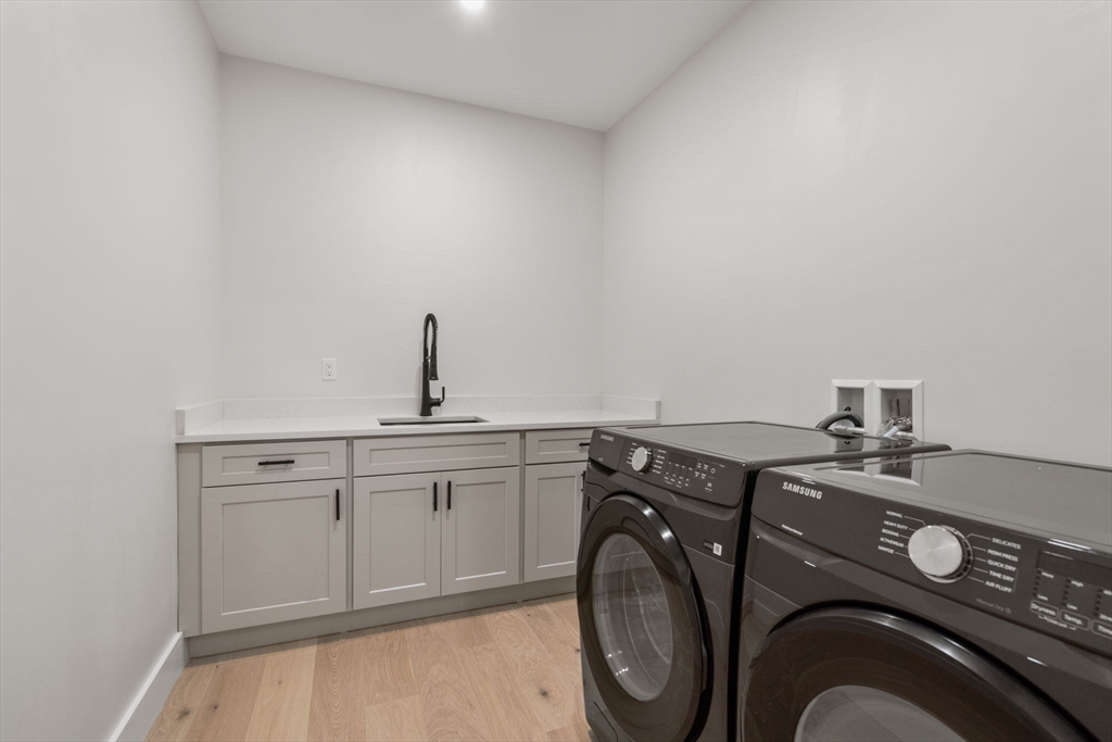 48 Cypress Road Milton, MA 02186 - Photo 29 of 39 a utility room with sink dryer and washer