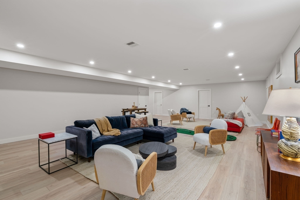 48 Cypress Road Milton, MA 02186 - Photo 31 of 39 a living room with furniture and a wooden floor