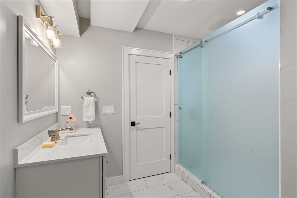 48 Cypress Road Milton, MA 02186 - Photo 32 of 39 a bathroom with a sink and a mirror