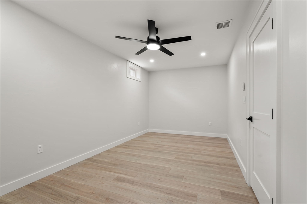 48 Cypress Road Milton, MA 02186 - Photo 33 of 39 a view of an empty room with wooden floor
