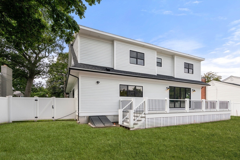 48 Cypress Road Milton, MA 02186 - Photo 38 of 39 a front view of a house with a yard and garage