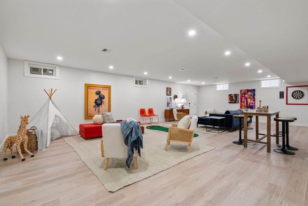 48 Cypress Road Milton, MA 02186 - Photo 6 of 39 a living room with furniture and a flat screen tv