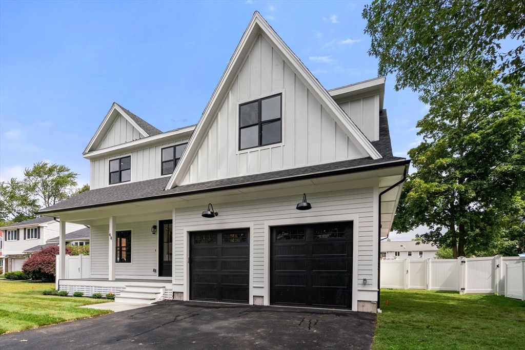 48 Cypress Road Milton, MA 02186 - Photo 7 of 39 a view of a house with a yard and garage