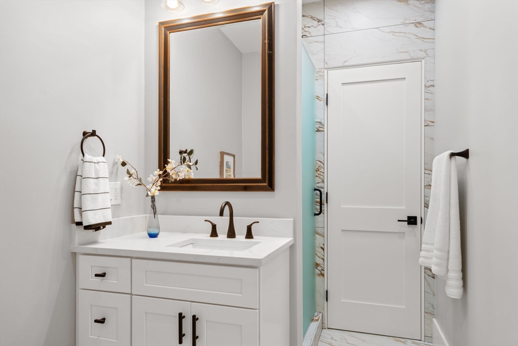 48 Cypress Road Milton, MA 02186 - Photo 9 of 39 a bathroom with a sink and a mirror