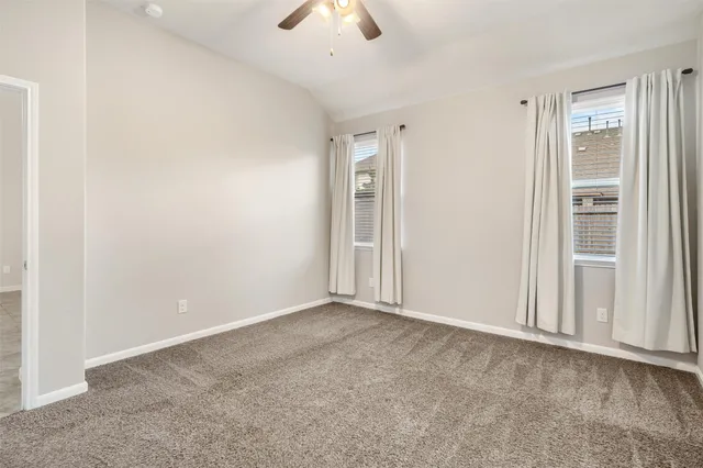 an empty room with a empty space and a ceiling fan