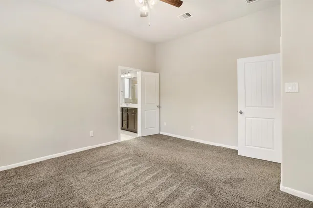 an empty room with a ceiling fan