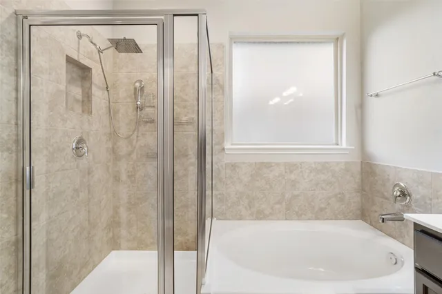 a white bath tub sitting next to a shower