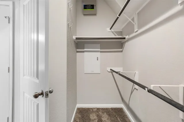 a view of staircase with railing and white walls