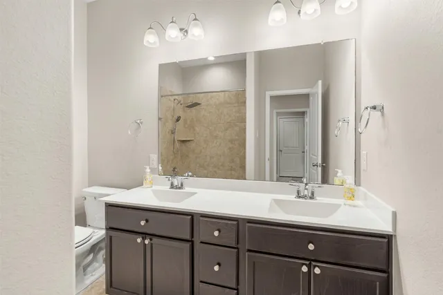 a bathroom with a sink double vanity and a mirror