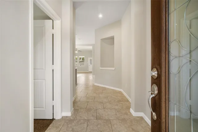 a view of a hallway with wooden shelves