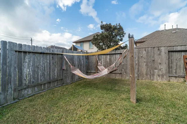 a view of a backyard with wooden fence