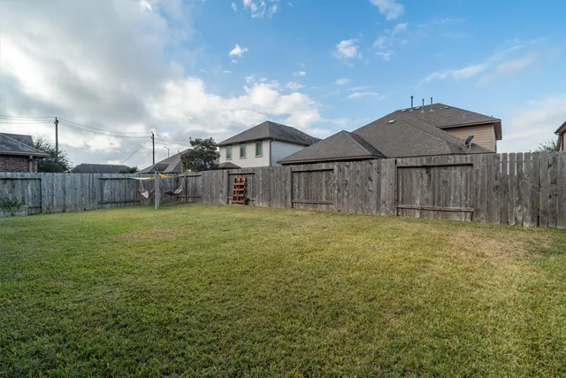 a backyard of a house with table and chairs