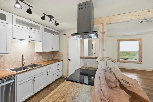 a view of a hallway with wooden floor and closet
